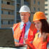 Portrait of two builders works at construction site